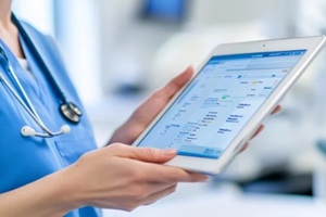 doctor checking the patient record on a tablet