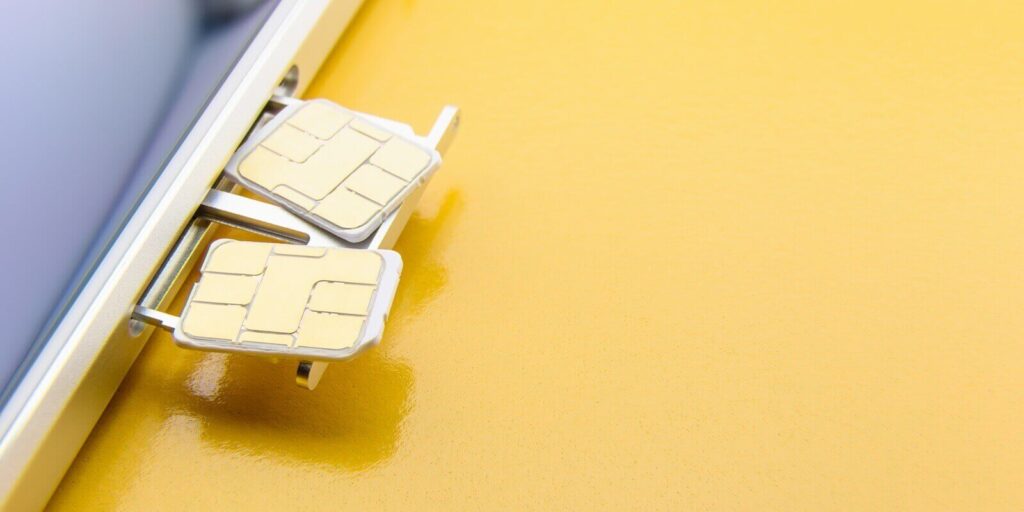 dual SIM card slot with two nano SIM cards on yellow background