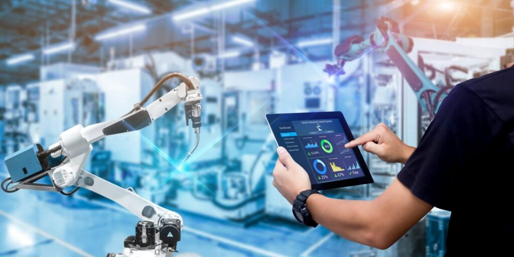 engineer hands holding tablet on blurred robot arm automation machine as background
