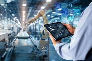 hands holding tablet on blurred automation machine as background
