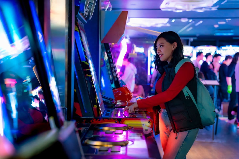 woman playing digital arcade game