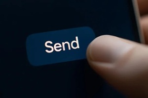 thumb pressing send button on a mobile device